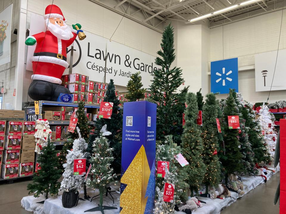 The Christmas section at Walmart featuring an inflatable Santa and Christmas trees.