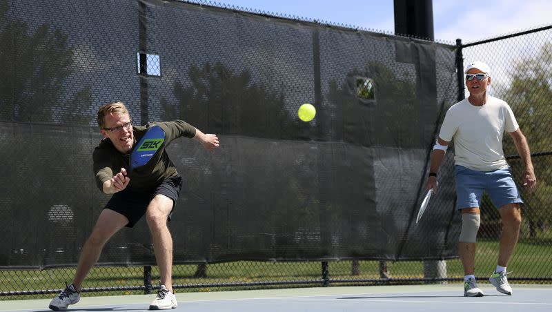 Jason Armstrong, left, and Rick Egan play pickleball at Fairmont Park in Salt Lake City on Friday, May 12, 2023.