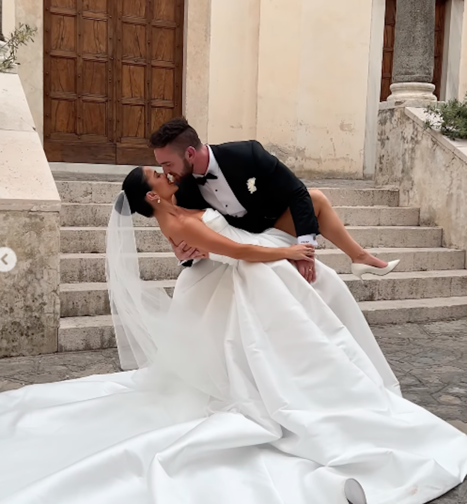 Rachel and Tobi kiss on wedding day