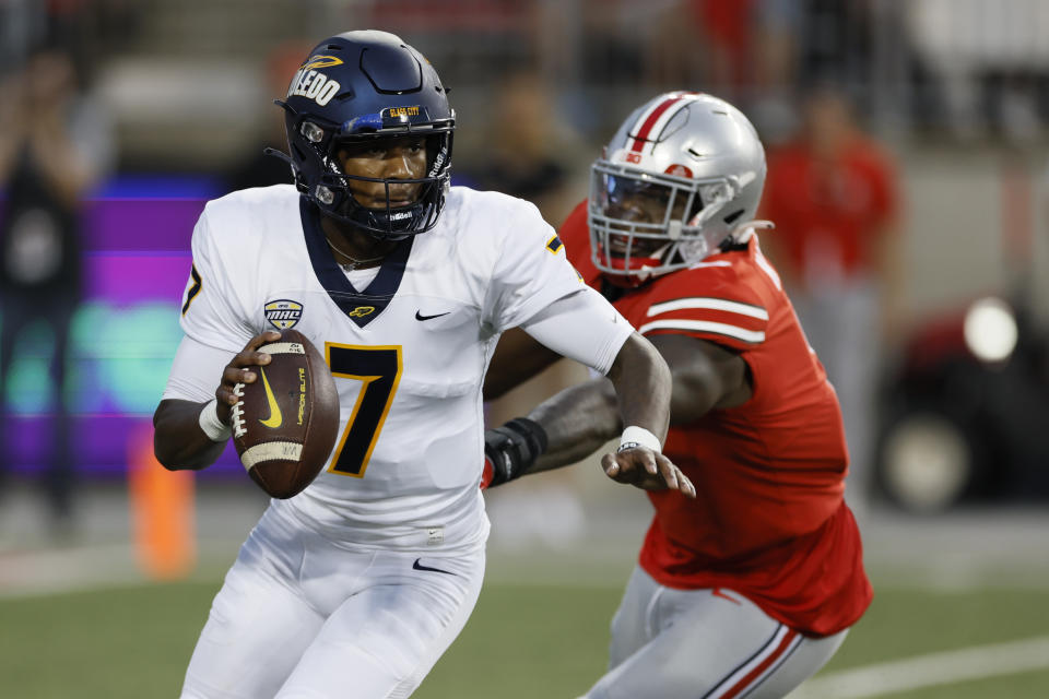 Ohio State defensive lineman Zach Harrison chases Toledo quarterback Dequan Finn out of the pocket during the first half of an NCAA college football game Saturday, Sept. 17, 2022, in Columbus, Ohio. (AP Photo/Jay LaPrete)