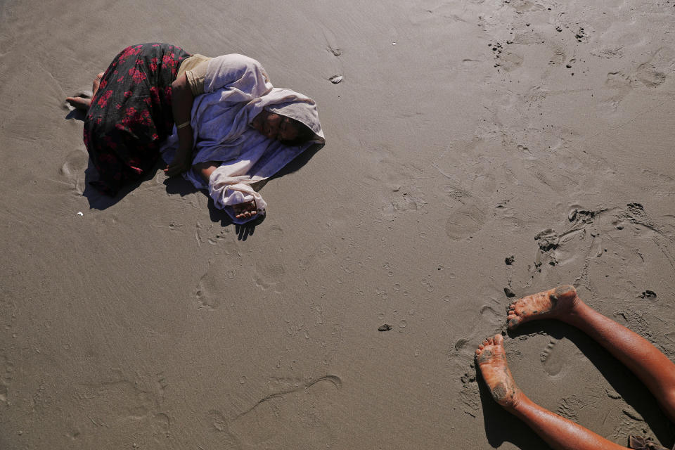 Rohingya refugees collapse from exhaustion after they arrive by a small wooden boat from Myanmar to the shore of Shah Porir Dwip, in Teknaf, near Cox's Bazar in Bangladesh, on Oct. 1. Reuters photographer Damir Sagolj: "Unlike those who were crossing the Naf River under the cover of the darkness, this group of Rohingya refugees were landing at the beach of Shah Porir Dwip in the broad daylight. They were totally exhausted&nbsp;-- I could only imagine what these people had been through before the rickety vessel brought them to Bangladesh. After landing, many just collapse. But not much later, as if awoken by survival instinct, they got back on their feet, collected children and the few possessions they brought with them, and continued by foot towards the refugee camps, a safe haven for those fleeing danger in Myanmar."