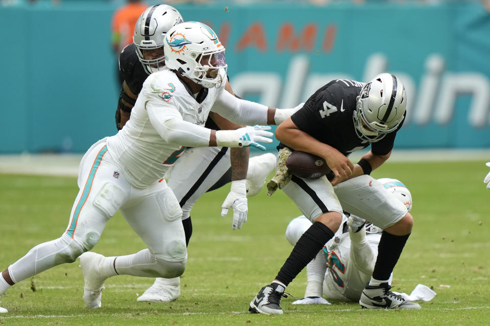 Las Vegas Raiders quarterback Aidan O'Connell (4) is sacked by Miami Dolphins linebackers Bradley Chubb (2) and Jaelan Phillips (15) during the second half of an NFL football game, Sunday, Nov. 19, 2023, in Miami Gardens, Fla. (AP Photo/Wilfredo Lee)