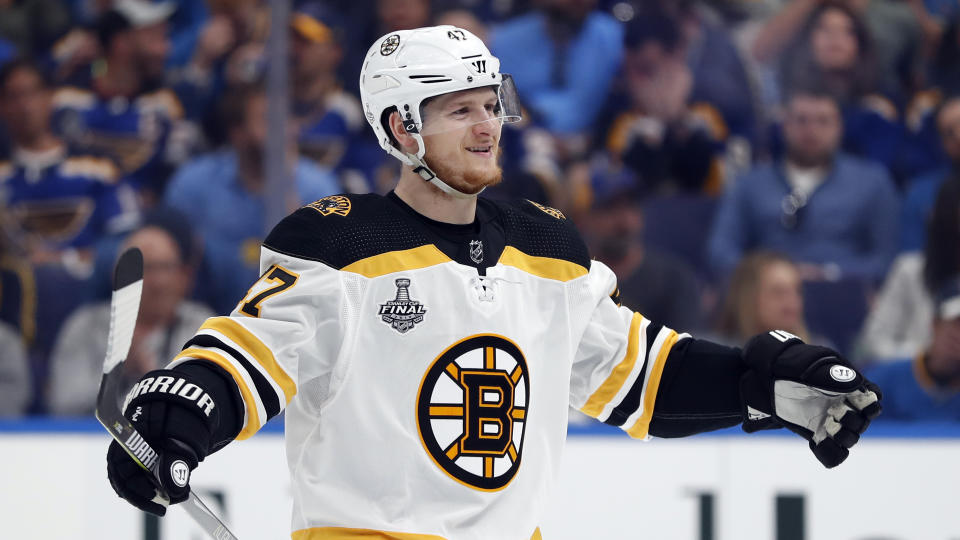 FILE - In this June 1, 2019, file photo, Boston Bruins defenseman Torey Krug celebrates a teammate's goal against the St. Louis Blues during the first period of Game 3 of the NHL hockey Stanley Cup Finals, in St. Louis. Patrice Bergeron wins the faceoff and Jake DeBrusk retrieves the puck for Torey Krug, who waits just long enough for Bergeron to set up and shoots it at his stick for a textbook deflection goal. This is the Boston Bruins’ masterful power play at its nearly unstoppable best. (AP Photo/Jeff Roberson, File)