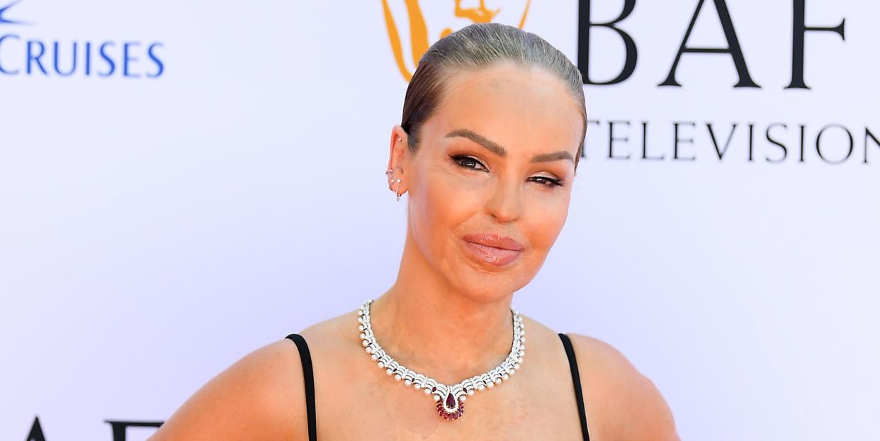 katie piper at 2024 bafta television awards, wearing a black dress and a silver necklace