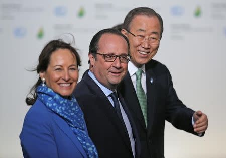 French President Francois Hollande (C), French Ecology Minister Segolene Royal (L) and United Nations Secretary General Ban Ki-moon wait to welcome head of states and governments as they arrive for the opening day of the World Climate Change Conference 2015 (COP21) at Le Bourget, near Paris, France, November 30, 2015. REUTERS/Christian Hartmann