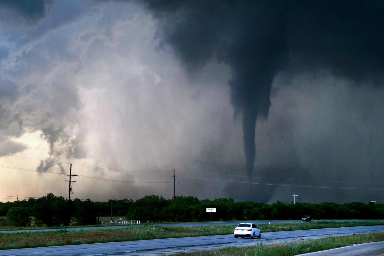<span>A tornado spins west of Hawley, Texas, on 2 May 2024.</span><span>Photograph: Ronald W Erdrich/The Abilene Reporter-News via AP</span>