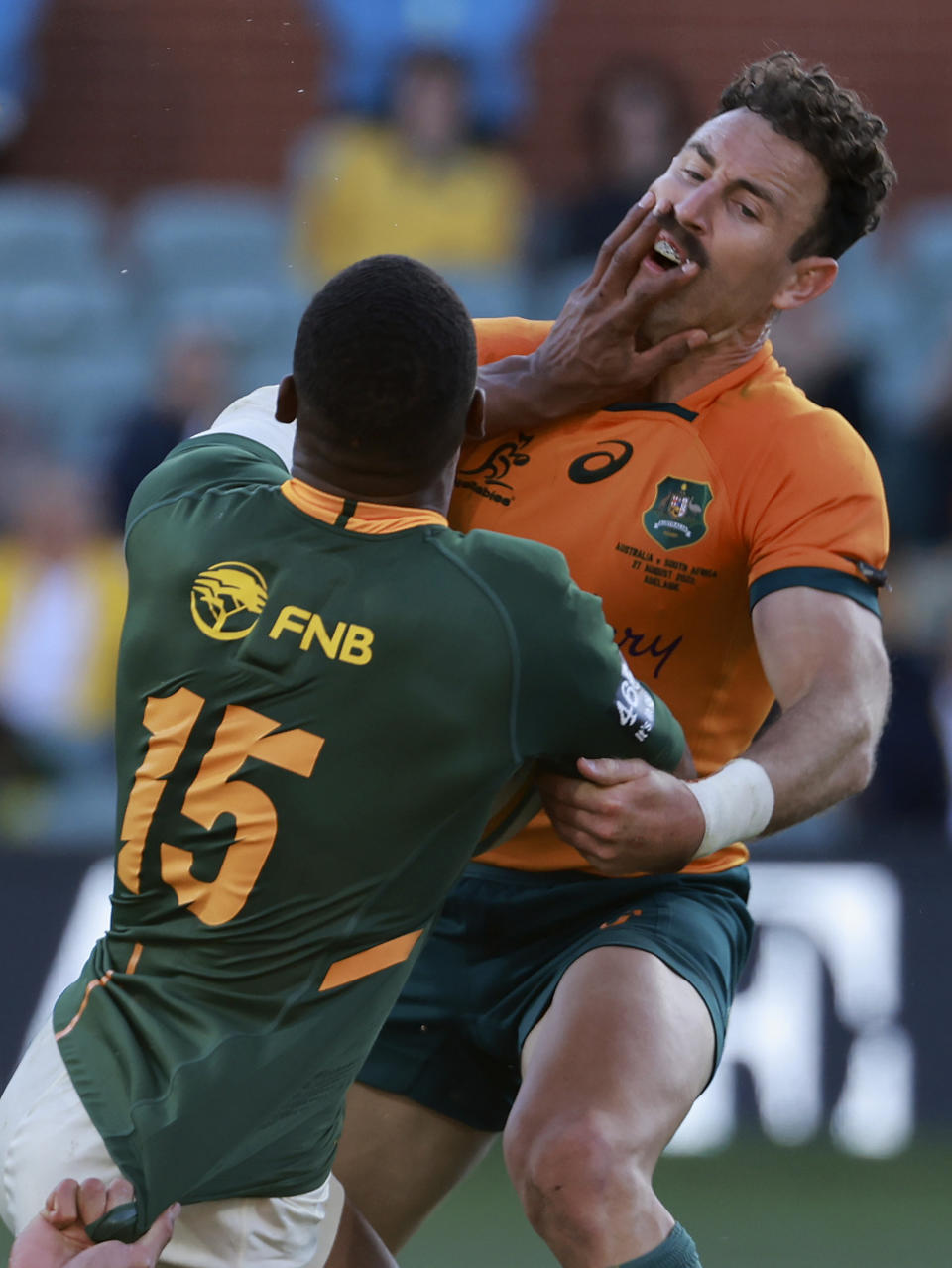 South Africa's Damian Willemse, left, fends off Australia's Nic White during their Champions Rugby test match in Adelaide, Australia, on Saturday, Aug. 27, 2022. (AP Photo/James Elsby)