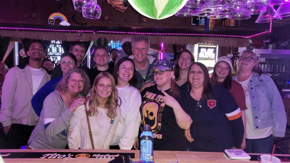 Will Ferrell, back center, stands for a group photo at The Basket Case Pub in Peoria. The actor visited on March 7.