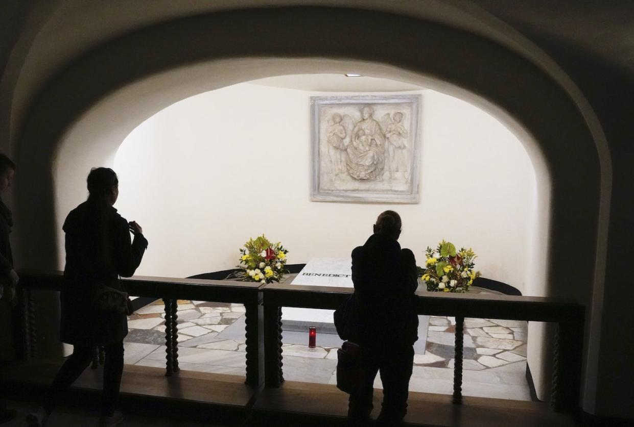 People pray in front of the tomb of the late Pope Emeritus Benedict XVI inside the grottos of St. Peter's Basilica, at the Vatican, on Jan. 8, 2023. <a href="https://newsroom.ap.org/detail/VaticanPopeEmeritusBenedictXVI/8d23357680c0479b865fc3ff47e71f54/photo?Query=pope%20benedict%20xvi&mediaType=photo&sortBy=&dateRange=Anytime&totalCount=15232&currentItemNo=4" rel="nofollow noopener" target="_blank" data-ylk="slk:AP Photo/Gregorio Borgia;elm:context_link;itc:0;sec:content-canvas" class="link ">AP Photo/Gregorio Borgia</a>