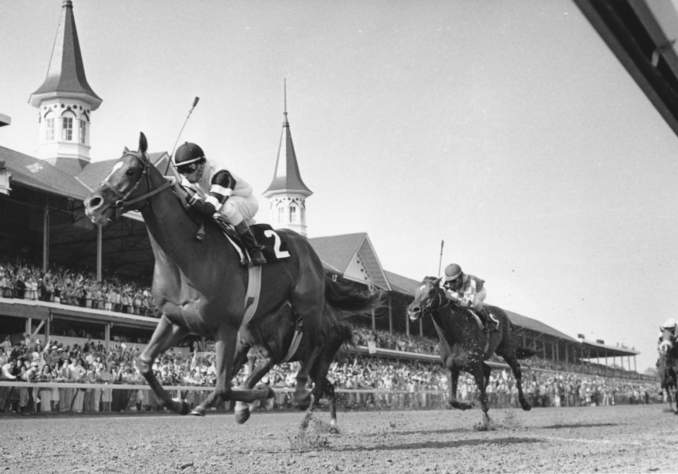 FILE - Affirmed, with jockey Steve Cauthen, crosses the finish line to win the 104th running of the Kentucky Derby in Louisville, Ky., on May 6, 1978. Alydar, with jocky Jorge Velasquez, finished second. Affirmed beat Alydar by 1 1/2 lengths. The two horses went head-to-head in the Preakness and Belmont that year, with Affirmed sweeping the series to become racing's third Triple Crown winner of the decade. (AP Photo)