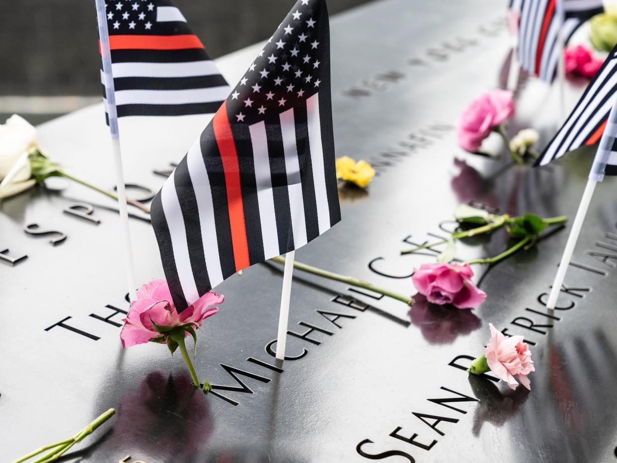 Flowers and American flags on 9/11 memorial