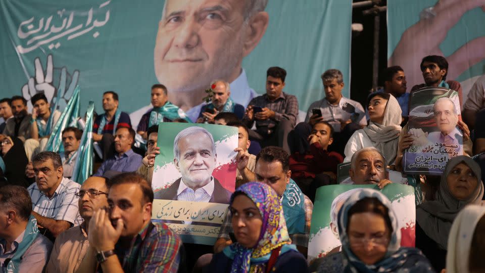 Supporters hold posters of Iranian presidential candidate Masoud Pezeshkian during a campaign event in Tehran, Iran, on July 3. - Majid Asgaripour/WANA/Reuters