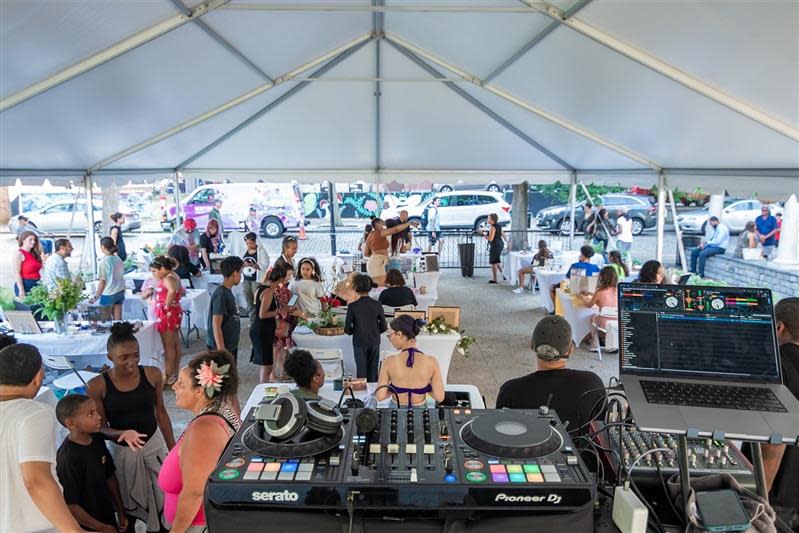 DJ Jules Flava provided the soundtrack as shoppers checked out offerings from the young vendors of the Dream Makers Market on Thursday, July 14, at Wing's Court in downtown New Bedford, as part of the annual Kids Rule AHA! Night. The market was organized by Buy Black NB, Our Sisters' School and Junior Achievement of Southern Massachusetts.