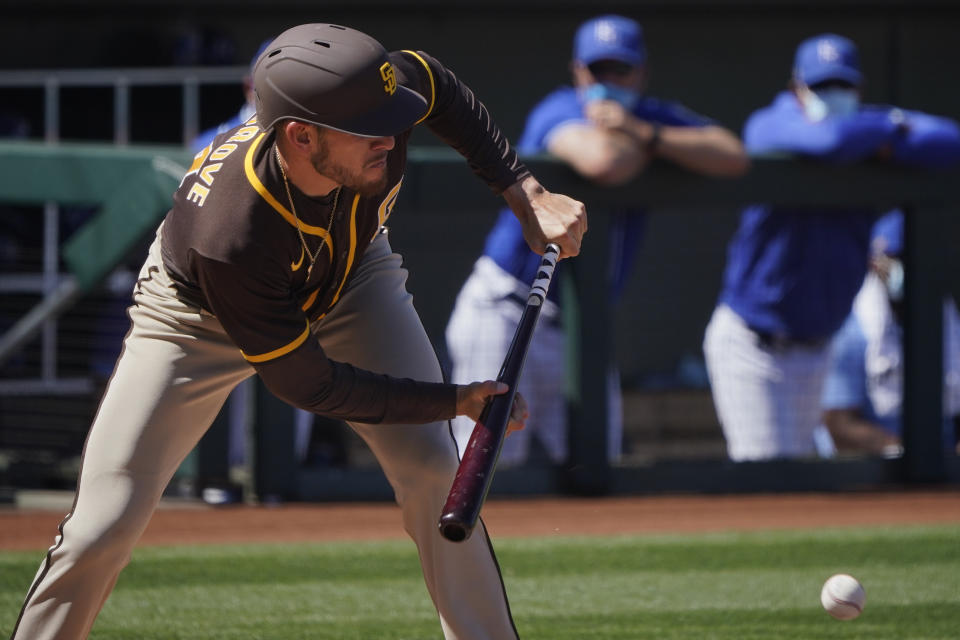 San Diego Padres's Joe Musgrove hits a bunt-single in the third inning of a spring training baseball game against the Kansas City Royals, Monday, March 22, 2021, in Surprise, Ariz. (AP Photo/Sue Ogrocki)