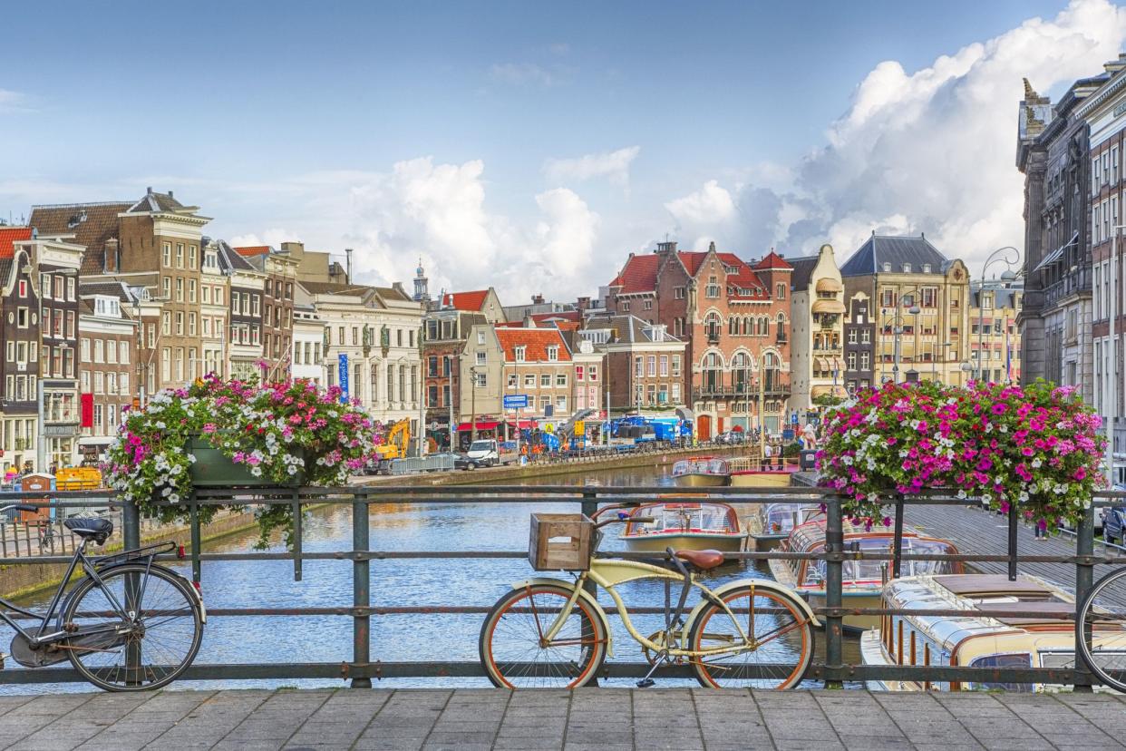 amsterdam canal with flowers and bike