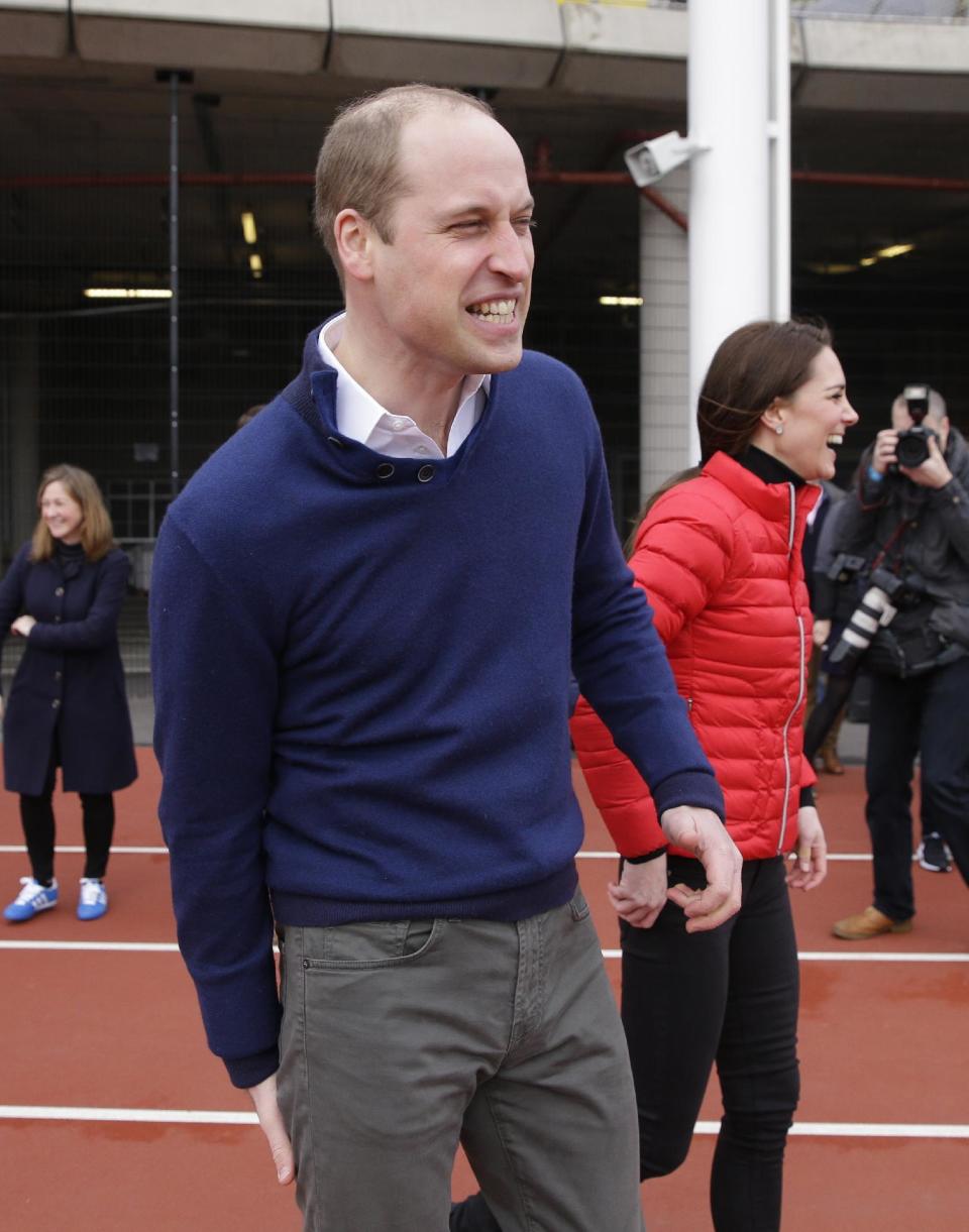 Britain's Prince William, reacts, with Kate, the Duchess of Cambridge, after running in a relay race, during a training event to promote the charity Heads Together, at the Queen Elizabeth II Park in London, Sunday, Feb. 5, 2017. (AP Photo/Alastair Grant, Pool)