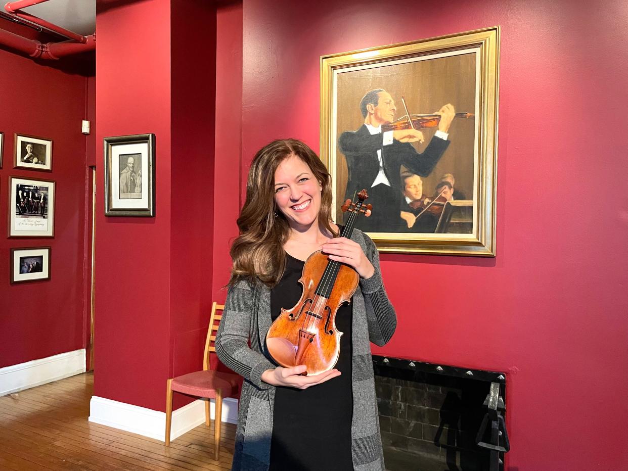 ProMusica concertmaster Katherine McLin poses with the organization's new violin. She will debut the instrument in two performances this weekend.