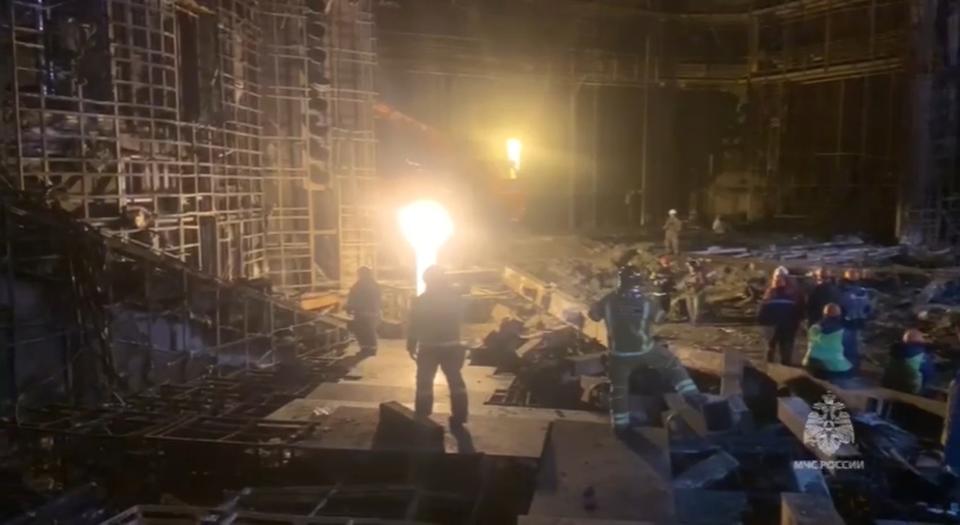 In this photo taken from video released by Russian Emergency Ministry Press Service on Tuesday, March 26, 2024, rescuers work in the burned concert hall after a terrorists attack on the building of the Crocus City Hall on the western edge of Moscow, Russia. Russia is still reeling from the attack Friday in which gunmen killed 139 people in the Crocus City Hall, a concert venue on the outskirts of Moscow. Health officials said about 90 people remain hospitalized, with 22 of them, including two children, in grave condition. (Russian Emergency Ministry Press Service via AP)