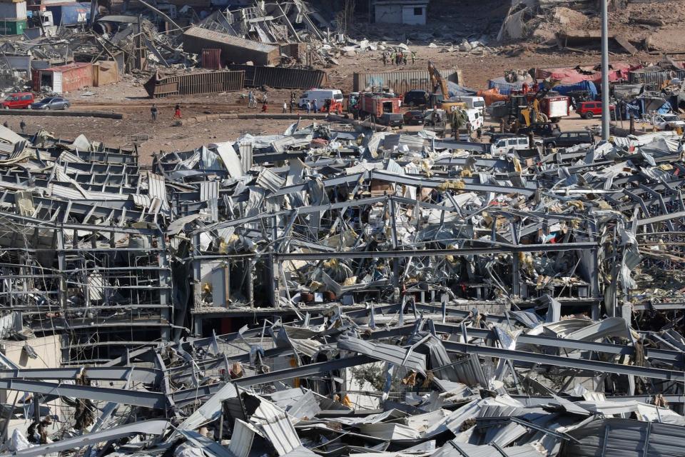 Rescue workers and security officers work at the scene of the explosion (AP)