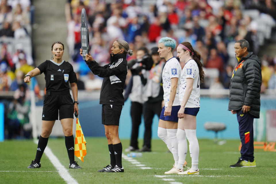 United States' Megan Rapinoe, center, and Rose Lavelle, second from right, wait to enter the game during the second half of the Women's World Cup Group E soccer match between the United States and Vietnam at Eden Park in Auckland, New Zealand, Saturday, July 22, 2023. (AP Photo/Abbie Parr)