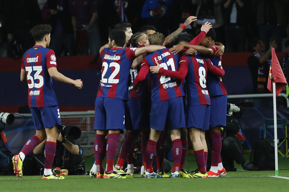 Barcelona's Raphinha celebrates with teammates after scoring the opening goal during the Champions League quarterfinal second leg soccer match between Barcelona and Paris Saint-Germain at the Olimpic Lluis Companys stadium in Barcelona, Spain, Tuesday, April 16, 2024. (AP Photo/Joan Monfort)