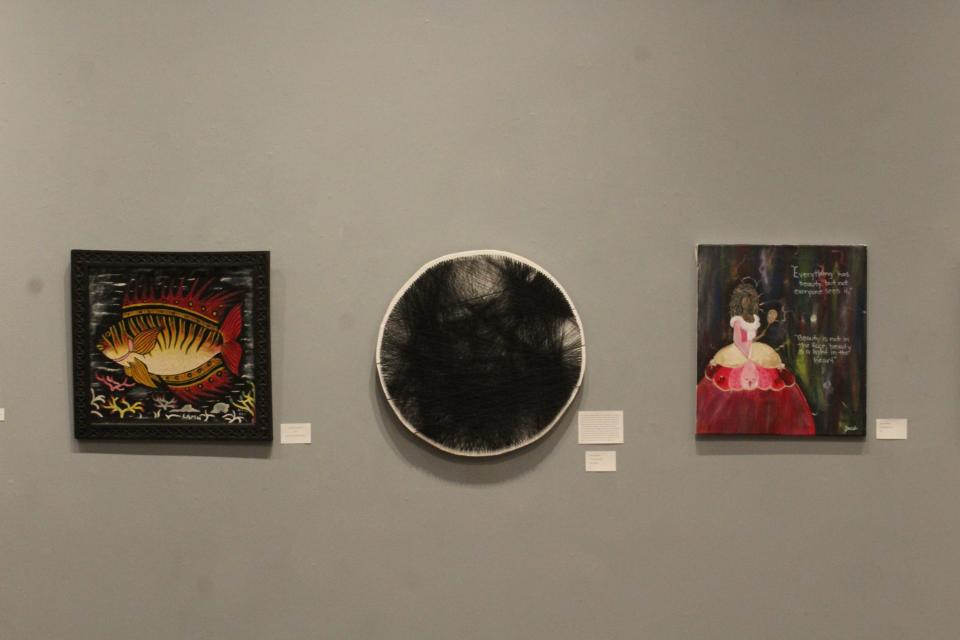 Three works of art are displayed at the Afrocentric Vision art exhibit at the Wayne Center for the Arts.