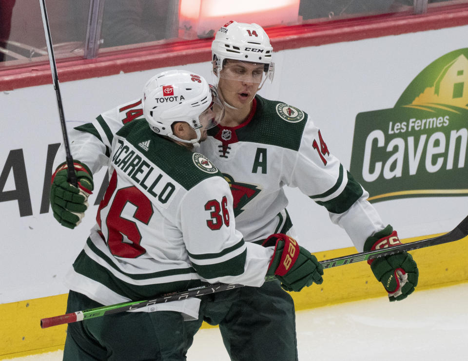 Minnesota Wild's Joel Eriksson Ek (14) celebrates his goal over the Montreal Canadiens with teammate Mats Zuccarello (36) during the second period of an NHL hockey game, Tuesday, Oct. 17, 2023 in Montreal. (Christinne Muschi/The Canadian Press via AP)