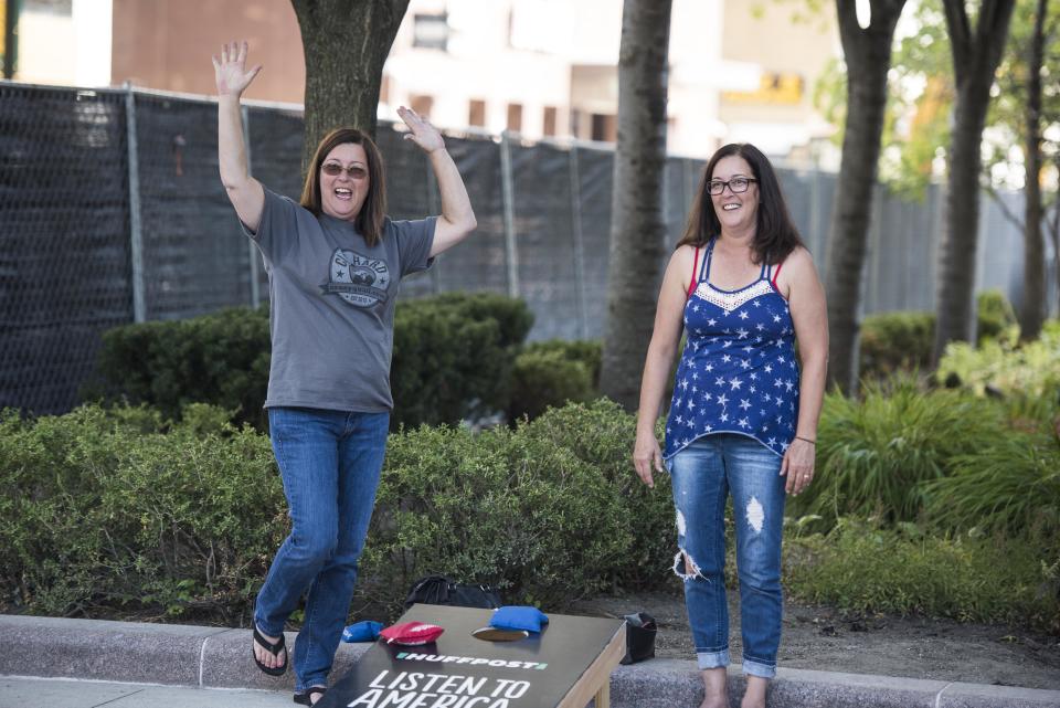 Wendy Agbay and Christy Barford play a game of cornhole.