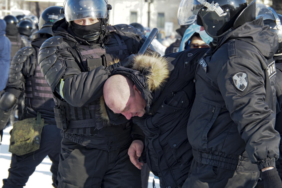 Police detain a man during a protest against the jailing of opposition leader Alexei Navalny in Khabarovsk, 6,100 kilometers (3,800 miles) east of Moscow, Russia, Saturday, Jan. 23, 2021. Authorities in Russia have taken measures to curb protests planned for Saturday against the jailing of Navalny. (AP Photo/Igor Volkov)