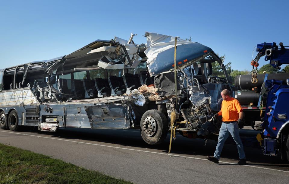 A damaged Greyhound bus is prepared for transport on Wednesday, July 12, 2023, from the scene of a fatal wreck on westbound Interstate 70 after the bus collided with a tractor-trailer near Highland, Ill. (Christian Gooden/St. Louis Post-Dispatch via AP)