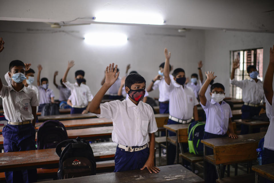Students attend a class at the Narinda Government High School as schools reopen after being closed for nearly 18 months due to the coronavirus pandemic in Dhaka, Bangladesh, Sunday, Sept.12, 2021. (AP Photo/Mahmud Hossain Opu)