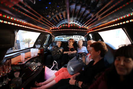 Holocaust survivors sit in a limousine as they are brought to take part in the annual Holocaust survivors' beauty pageant in Haifa, Israel October 14, 2018. REUTERS/Corinna Kern