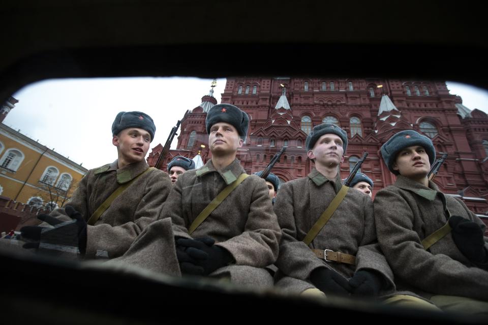 Russian soldiers dressed in Red Army World War II winter uniforms sit in a truck as they wait to take a part in a reconstruction of a World War II-era parade in Moscow's Red Square, Russia, Thursday, Nov. 7, 2019. The Nov. 7, 1941 parade saw Red Army soldiers move directly to the front line in the Battle of Moscow, becoming a symbol of Soviet valor and tenacity in the face of overwhelming odds. (AP Photo/Alexander Zemlianichenko)
