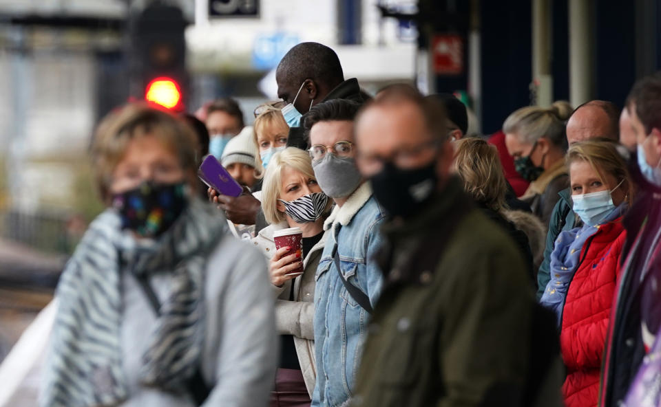 Passengers wait for trains at Ashford Railway Station in Kent, as mask wearing on public transport becomes mandatory to contain the spread of the Omicron Covid-19 variant. Picture date: Tuesday November 30, 2021.