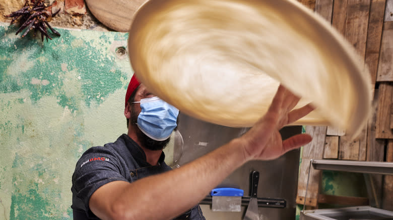 Chef tossing pizza dough