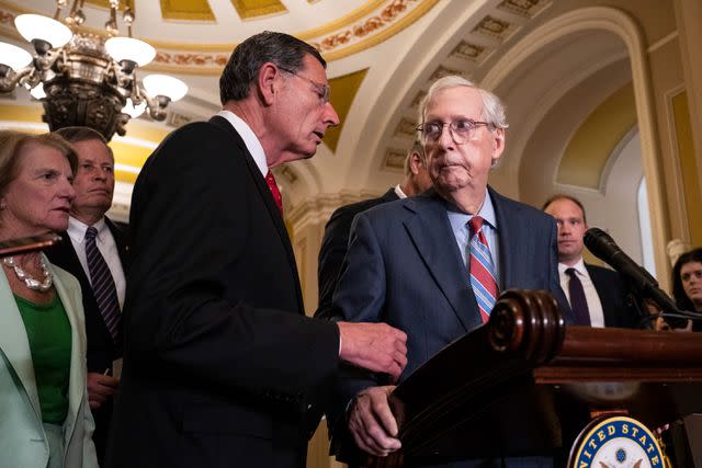 <p>Drew Angerer/Getty Images</p> Mitch McConnell's Senate colleague steps in after he freezes during a news conference on July 26, 2023