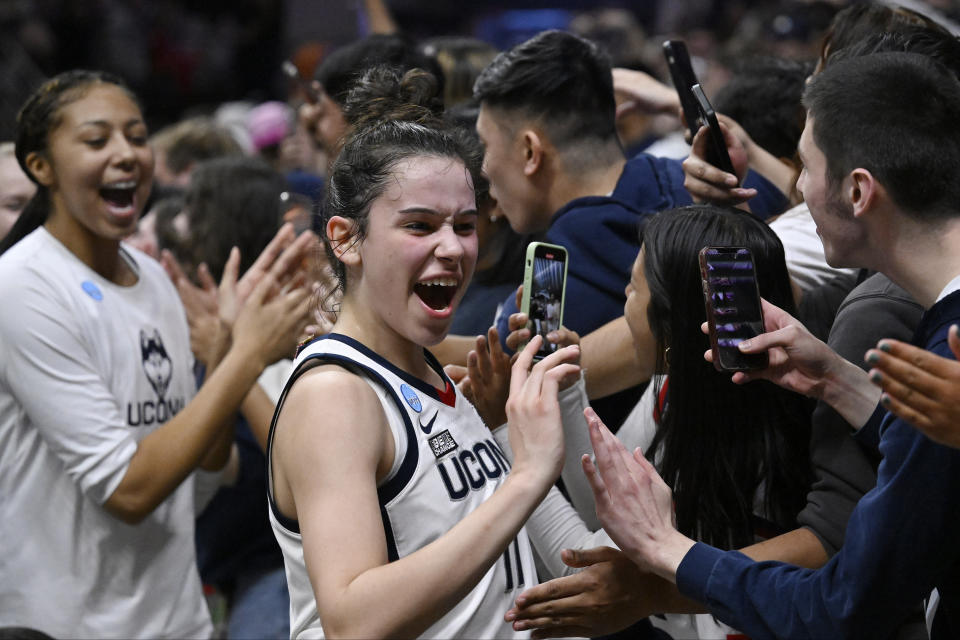 UConn's Lou Lopez Senechal (11) celebrates with students after her team's win over Baylor in a second-round college basketball game in the NCAA Tournament, Monday, March 20, 2023, in Storrs, Conn. (AP Photo/Jessica Hill)