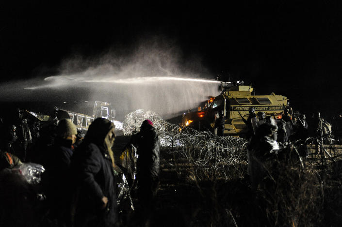 <p>Police use a water cannon on protesters during a protest against plans to pass the Dakota Access pipeline near the Standing Rock Indian Reservation, near Cannon Ball, N.D., on Nov. 20, 2016. (Stephanie Keith/Reuters) </p>