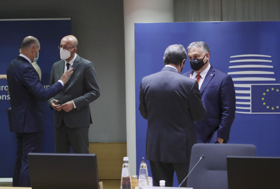 Hungary's Prime Minister Viktor Orban, right, speaks with Cypriot President Nicos Anastasiades, second right, during a round table meeting at an EU summit in Brussels, Monday, May 24, 2021. European Union leaders are expected, during a two day in-person meeting, to focus on foreign relations, including Russia and the UK. (Yves Herman, Pool via AP)