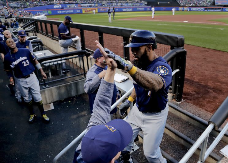 Milwaukee Brewers' Eric Thames, right, is congratulated by teammates and coaches after hitting a two-run home run against the New York Mets during the first inning of a baseball game, Wednesday, May 31, 2017, in New York. (AP Photo/Julie Jacobson)