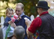 Britain's Prince William holds Princess Charlotte as she is given a balloon animal during a children's tea party at Government House in Victoria, British Columbia, Canada September 29, 2016. REUTERS/Jonathan Hayward/Pool