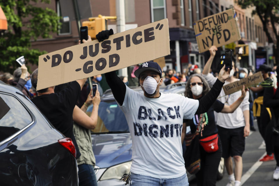 FILE - In this Tuesday, June 2, 2020 file photo, Omar Fernandez takes part in the Prayerful Protest march for George Floyd in the Brooklyn borough of New York. Floyd died after being restrained by Minneapolis police officers on Memorial Day, May 25. (AP Photo/Frank Franklin II)