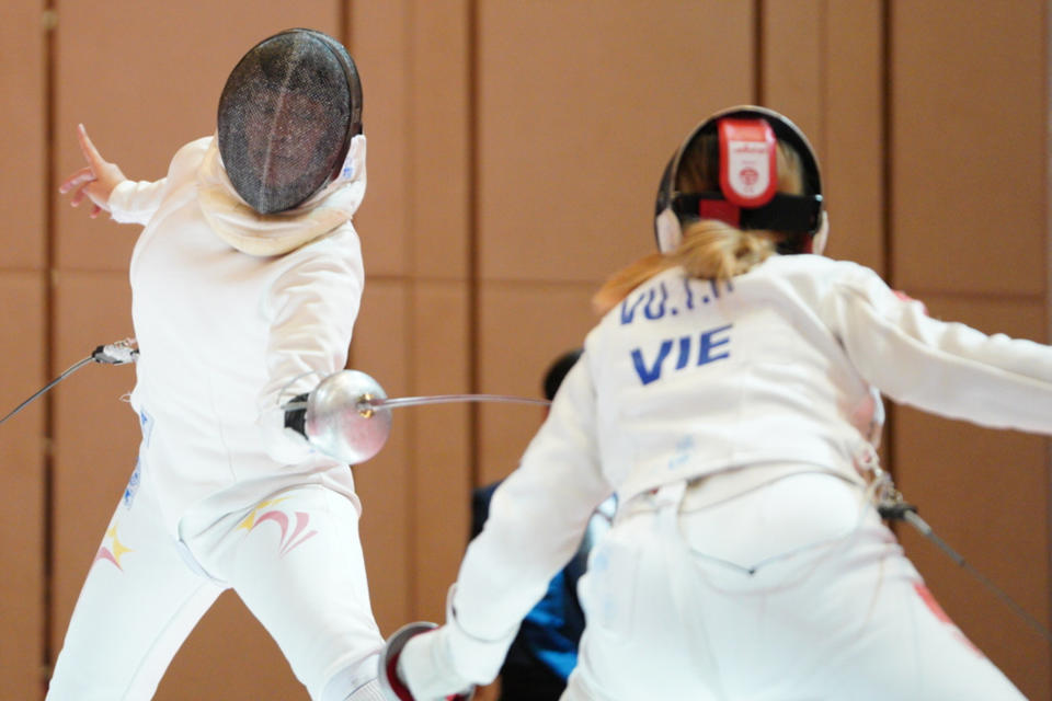 Singapore fencer Elle Koh (left) during her women's epee final against Vietnam's Vu Thi Hong at the 2023 SEA Games. (PHOTO: Sport Singapore/Bryan Foo)