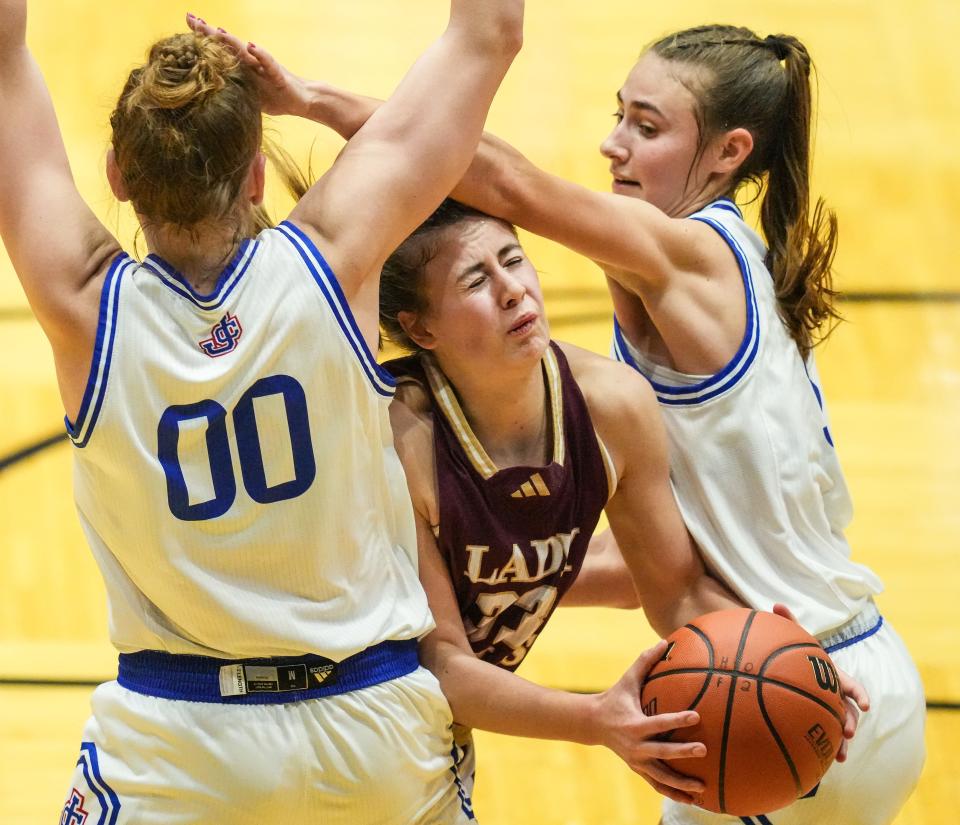 Columbia City Eagles Addison Baxter (33) attempts to push past Jennings County Panthers Juliann Woodard (00) on Thursday, Oct. 5, 2023, during the Hall of Fame Classic girls basketball tournament at New Castle Fieldhouse in New Castle. The Columbia City Eagles defeated the Jennings County Panthers, 56-47.