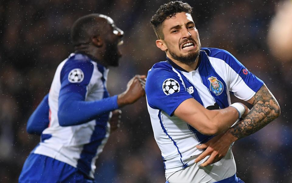 Alex Telles of Porto celebrates scoring the winning penalty in extra time during the UEFA Champions League Round of 16 Second Leg match between FC Porto and AS Roma - Stuart Franklin - UEFA/UEFA via Getty Images