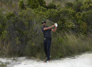 Tony Finau, of the United States, watches his shot from the sands at the first hole during the second round of the Hero World Challenge PGA Tour at the Albany Golf Club, in New Providence, Bahamas, Friday, Dec. 2, 2022. (AP Photo/Fernando Llano)