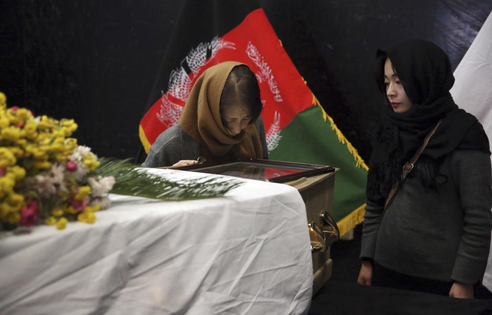 From left, the wife and daughter of slain Japanese physician Tetsu Nakamura stand next to his coffin after they arrived to pay their tribute to Nakamura at the Afghan military hospital in Kabul, Afghanistan, Friday, Dec. 6, 2019. (AP Photo/Tamana Sarwary)