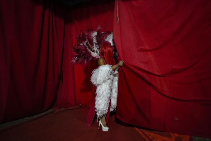 Timoteo Circus performer Yendely Anahis exits the stage, on the outskirts of Santiago, Chile, Saturday, Dec. 10, 2022. Since 1968, the Timoteo Circus has broken barriers faced by the Chilean LGBTQ community with a show aimed at an adult audience. (AP Photo/Esteban Felix)