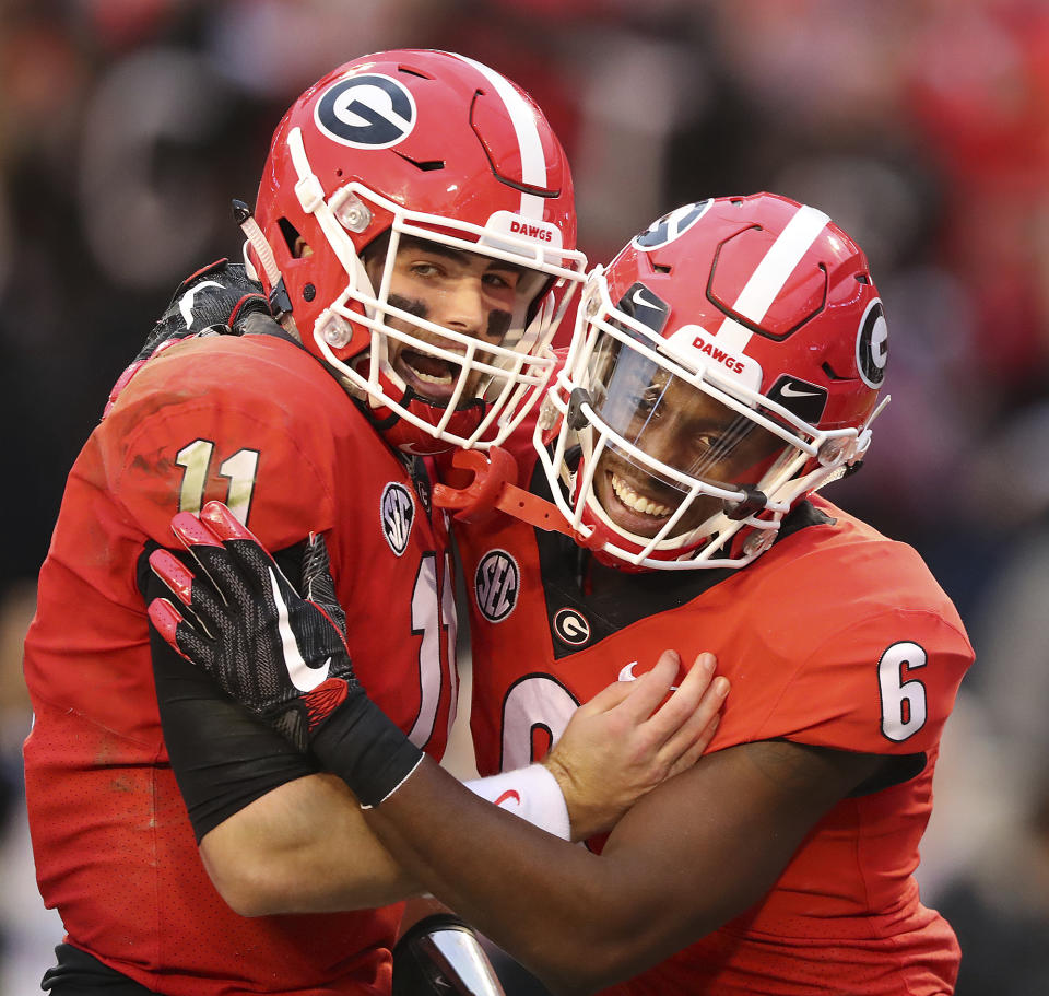 Georgia quarterback Jake Fromm celebrates his touchdown throw with wide receiver Javon Wims, who caught it, during the first half of a NCAA college football game against Kentucky, Saturday, Nov. 18, 2017, in Athens, Ga. (Curtis Compton/Atlanta Journal-Constitution via AP)