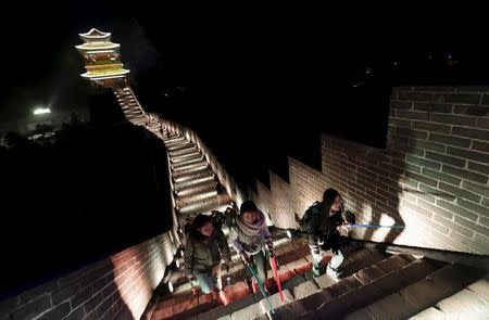 Fans holding toy lightsabers arrive at Juyongguan section of the Great Wall of China for a promotional event for "Star Wars: The Force Awakens" film, on the outskirts of Beijing, China, October 20, 2015. REUTERS/Jason Lee